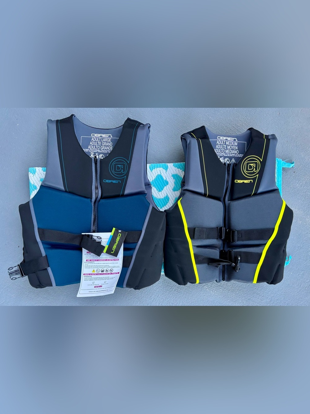 One adult large and one adult medium O'Brien Neoprene Life Vest - Blue/Grey